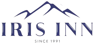 Footer Template featuring the Iris inn logo with mountains in the background.